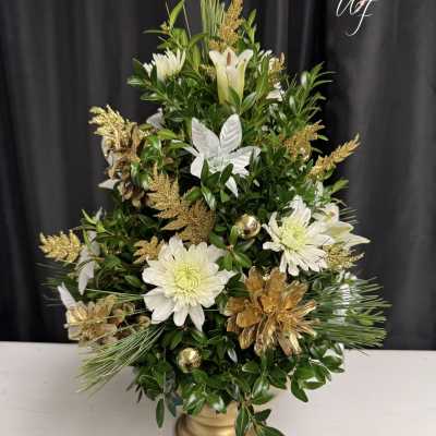 White flowers and gold accents in a gold vase