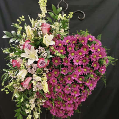 Heart-shaped floral wreath with pink daisies, roses, and white lilies