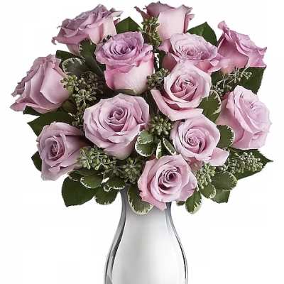 Lavender roses arranged in a clear glass vase