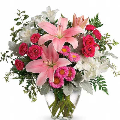 Pink lilies and roses in a clear glass vase