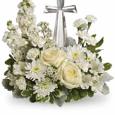 White floral arrangement with a silver cross centerpiece