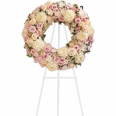Pastel floral wreath on a white stand
