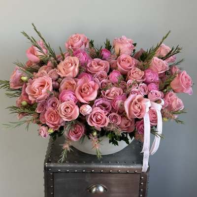 Large pink rose bouquet in a low white container