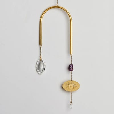 Gold U-shaped hanging ornament with crystal drops, purple bead, and etched eye charm