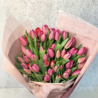 Bouquet of pink tulips wrapped in pale pink paper