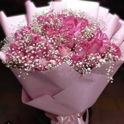 Pink rose bouquet with baby's breath wrapped in pink paper