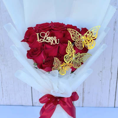 Bouquet of red roses with gold butterfly picks and a red ribbon