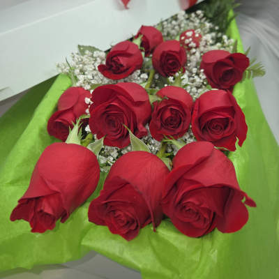 Box of red roses with baby's breath and a red ribbon bow