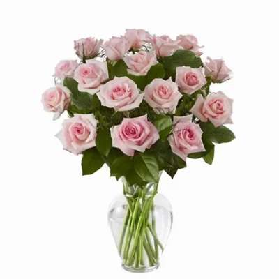 Pink roses arranged in a clear glass vase