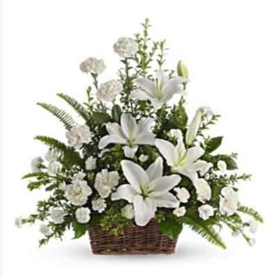 White lilies and carnations arranged in a wicker basket