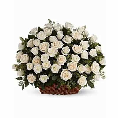 White rose arrangement in a wicker basket