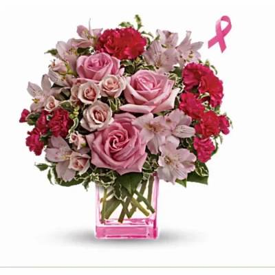 Pink arrangement of roses, carnations, and alstroemeria in a pink glass cube vase with a pink ribbon icon