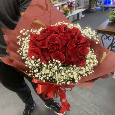Bouquet of red roses with white baby's breath in red wrap