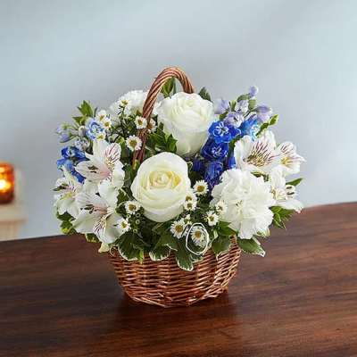 White and blue flower basket in a wicker basket