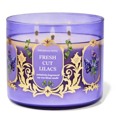 Purple glass candle with three wicks and floral label