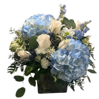 Blue hydrangeas and white roses in a dark vase