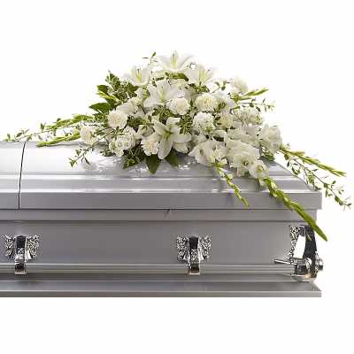 White floral spray arranged on a silver casket