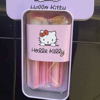 Hello Kitty tin box holding pink candles