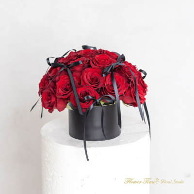 Red rose bouquet in a black box with black ribbon bows