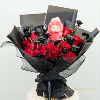 Bouquet of red and black roses with a pink plush toy