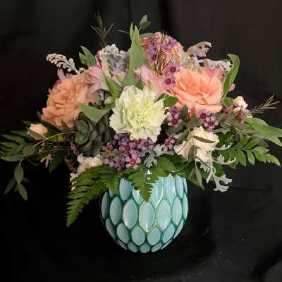 Mixed bouquet in a turquoise mosaic vase with peach, pink, and white flowers