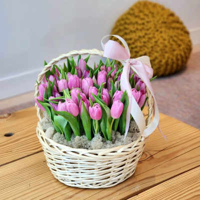 Basket of pink tulips with a pale ribbon bow