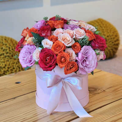 Pink hatbox arrangement of roses with a satin ribbon
