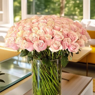 Large bouquet of pale pink roses in a clear glass vase