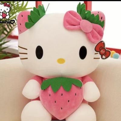 Hello Kitty plush toy holding a strawberry, with a pink bow