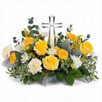 Yellow and white floral arrangement with a clear cross centerpiece