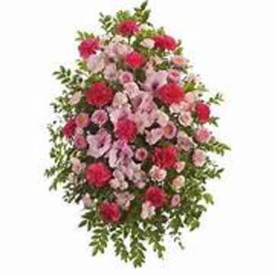 Standing spray of pink and red flowers with greenery