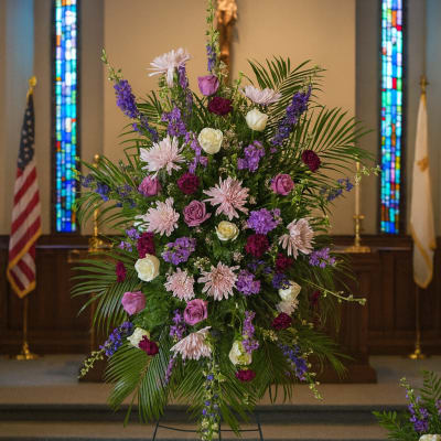 Tall church standing spray with pink, purple, and white flowers