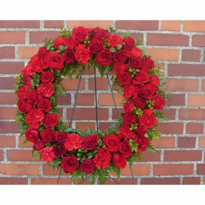 Red rose and carnation wreath on a stand