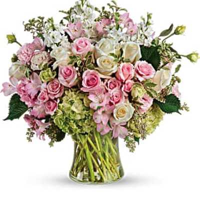 Pink and white rose bouquet in a clear glass vase