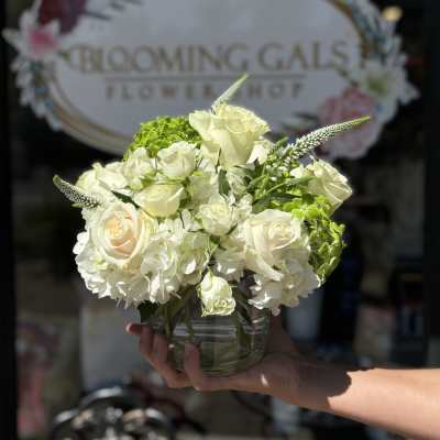 White rose and hydrangea bouquet in a clear glass vase