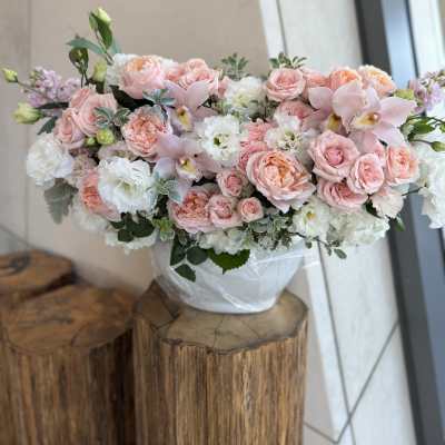 Pink and white floral arrangement in a white vase