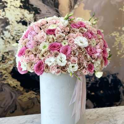 Pink and white rose arrangement in a tall white box with ribbon