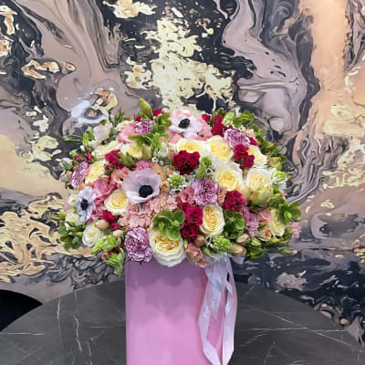 Large mixed bouquet in a pink cylindrical box with ribbon