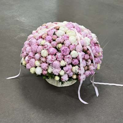 Large basket of pink and white peonies with ribbon streamers