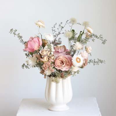 Pink and white bouquet in a white vase