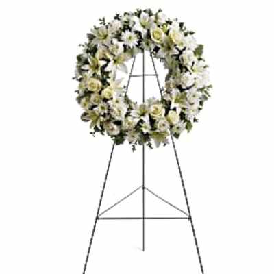 White floral funeral wreath on a standing easel