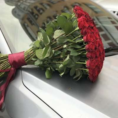 Bouquet of red roses tied with a burgundy ribbon