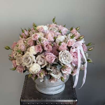 Large bouquet of pale pink and white roses in a glass vase