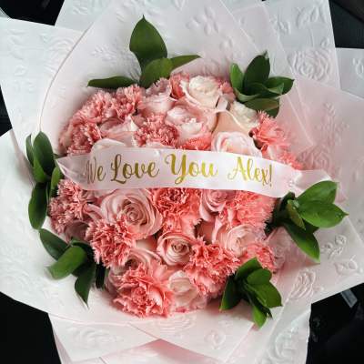 Pink rose and carnation bouquet with a "We Love You Alex!" ribbon