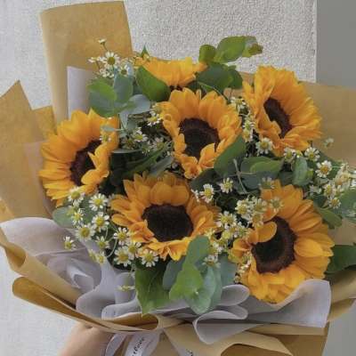 Bouquet of sunflowers with small white daisies and eucalyptus