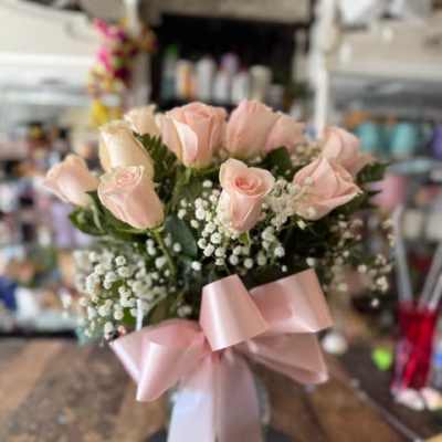 Bouquet of pale pink roses with baby's breath and a pink ribbon