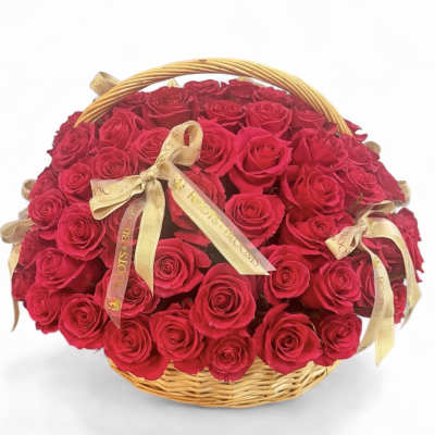 Basket of red roses with gold ribbons
