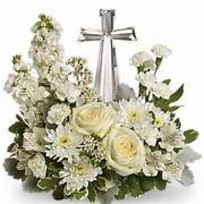 White floral arrangement with a silver cross centerpiece