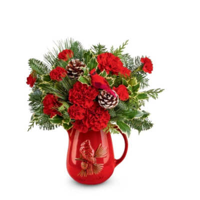 Red carnations in a red pitcher with pinecones and evergreen sprigs