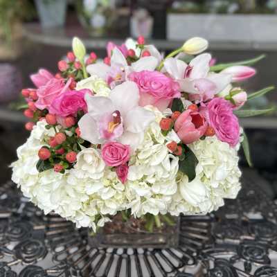 Pink and white floral arrangement in a clear glass vase